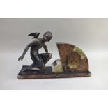 R. COUSYN An Art Deco mantel clock, with kneeling painted metal figure mount, inscribed "R. Cousyn a