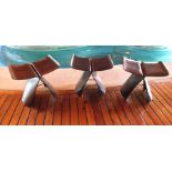 A set of three bentwood, possibly ebony veneered, ply stools, designed by Sori Yanagi, with brass