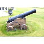 A late 18th/early 19th century iron cannon, on a naval oak gun carriage with securing rings, for 5.
