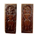 A pair of 16th century oak furniture panels, each with a full length figure of a man in broad