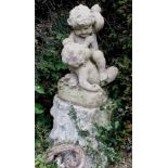 A reconstituted stone figure group of two fighting putti, 55cm high, together with tree stump effect
