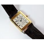 A gentleman’s Jaeger Le Coultre Reverso gold plated quartz wristwatch, the rectangular silvered dial