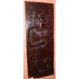 An early 16th century Flemish carved oak furniture panel, with full length figure of a man