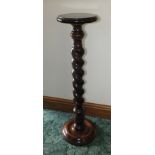 A polished and stained wood jardiniere stand, having substantial barley twist stem, 93cm high