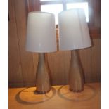 A pair of contemporary oak table lamps with chevron inlay to bases, fitted with cream fabric shades,