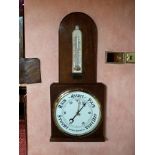 A Victorian oak aneroid barometer, the 13inch white dial unsigned, below the arched top with china