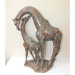 A carved soapstone figural group depicting a giraffe and her calf, the base signed "Sam Munhamo",