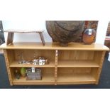 A "Cadman" contemporary oak bookcase, having demi-lune ends with brass studded strips, chevron