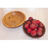 Two carved wooden circular bowls, each approximately 30cm diameter, one containing a selection of