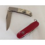 Two "Victorinox" multi-blade pen knives, and a scrimshaw effect decorated pen knife