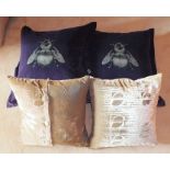 Four Scottish made velvet scatter cushions, comprising two purple timorous beasties, and two "DNA"