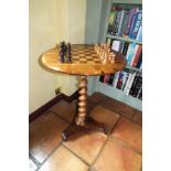 A Victorian rosewood veneered chess table, having circular top inlaid with chequer board, raised