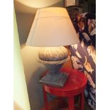 A modern composite urn table lamp with light caramel shade, 62cm high overall and a modern