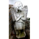 A 19th century marble statue of an angel wearing robes, her hands crossed across her breast, with