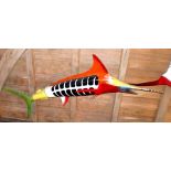 A life size fibreglass model of a Marlin, brightly painted with jigsaw effect primary colour body,