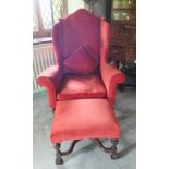 A William and Mary walnut wing back elbow chair, the high back with scroll arch, scroll arms and