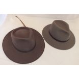 An "Akubra" pure fur felt cattleman Australian hat with feather, size 61 and another "Akubra" pure