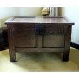 A late 17th century oak chest of small proportions, the twin panel top, foliate arcaded top rail,