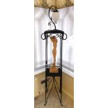 A free standing painted raffia and metal two-tier stand, the upper section housing a table light,