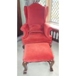 A William and Mary walnut ratchet high wing back elbow chair with arched back, the scroll arms