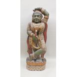 An early 20th century carved and painted wood Indian Goddess, having green patina, in decorative