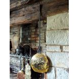 A 17th century warming pan, the brass domed lid embossed with fan medallions and punched six point