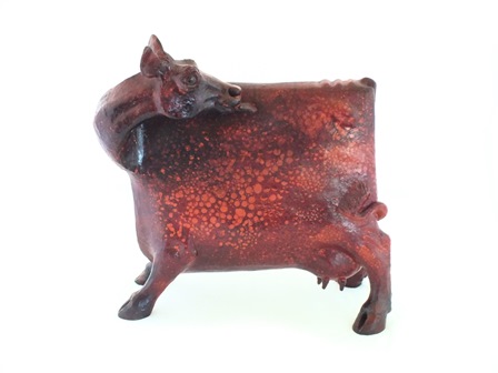 A bronze figure of a cow standing four square, it's head turned licking its back, green - Image 2 of 4