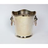 A silver plated ice bucket, of plain polished tapering form with shaped gadrooned rim and two lion