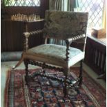 A late 17th century Flemish walnut elbow chair with roundel ended arms and twist, ring and