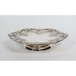 A pedestal silver platter, Henry Atkin, Sheffield 1957, of shaped circular form with vine and