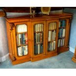 A Victorian oak breakfront bookcase, the moulded edge top over two pairs of panel glazed doors,