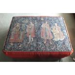 A large upholstered stool, the top with 17th century design tapestry cover, featuring four musicians