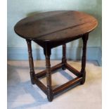 A late 17th century elm and oak oval side table, the triple plank top, rectangular frieze with