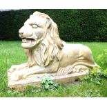 A reconstituted stone lion after the antique, on a rectangular plinth base, 74cm high by 105cm