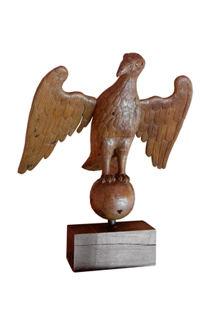 A 16th century carved oak lectern figure of an eagle, modelled perched on a sphere, wings open,