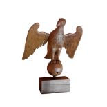 A 16th century carved oak lectern figure of an eagle, modelled perched on a sphere, wings open,