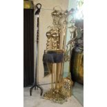 A 19th century design brass fireside companion set, the decorative stand holding a shovel, poker and