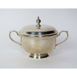 A Tiffany & Co sterling silver two handled sugar bowl and cover, the bowl of plain polished circular