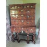 A William and Mary figured walnut chest on stand, the rectangular top with moulded cornice,