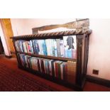 A pair of oak open bookcases, each having carved decorative top edge, linen fold panel ends, on