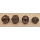 Four decorative cannon balls, two being wooden, close nailed all over, 11.5cm