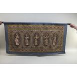 An Eastern wall hanging, five panels with raised figures, embroidered in wirework, sequins and glass
