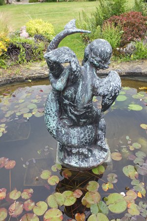 A 20th century bronze fountain figure in the form of a winged cherub riding on the back of an exotic - Image 3 of 4