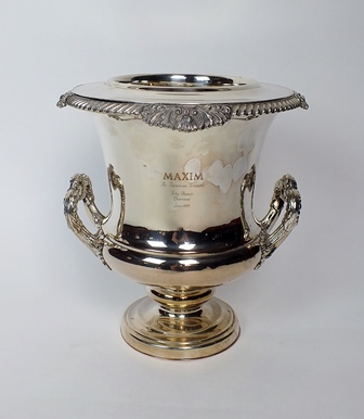 A silver plated wine cooler, of campagna form, the plain polished body engraved ‘Maxim An American