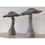 Two late 20th century carved and stained wood mushrooms, smallest 50cm high