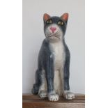 A 20th century carved polychrome wood model of a seated cat, grey and white with pink nose, 37cm