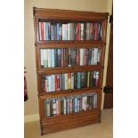 An Edwardian oak Globe Wernicke design sectional bookcase, having four glazed up and over doors,