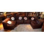 A "De Sede" brown leather upholstered sectional seating unit comprising; two corner seats and four