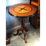A Victorian rosewood circular tripod side table, the top with satinwood centre and ebony four