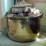 A 19th century brass pan, with iron swing loop handle, 75cms, diameter, 45cms high